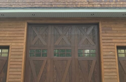 Wooden garage door with "X "overlay on panels